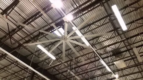 HVLS ceiling fan under a metal roof structure improving air movement in airport food courts.