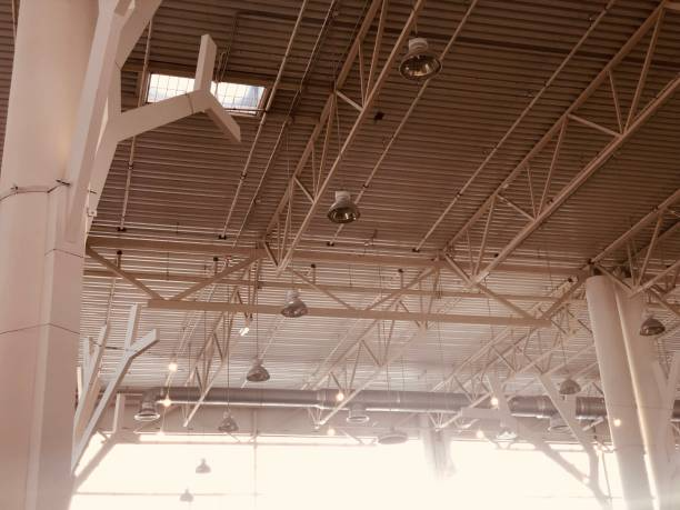 Industrial ceiling fans in a large sports hall providing cooling and safety.