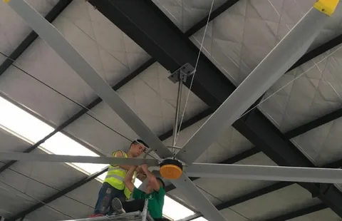 Installation of large ceiling fan to boost calf barn ventilation and prevent pneumonia.