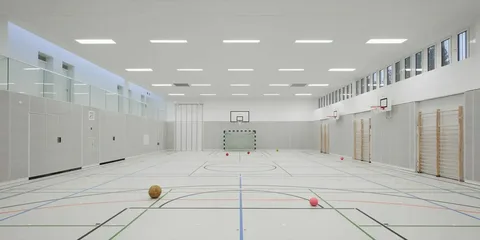 Sport hall showing ventilation systems comparing air conditioning and ceiling fans.